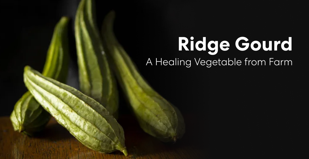 Fresh ridge gourd vegetables arranged on a wooden surface against a dark background.