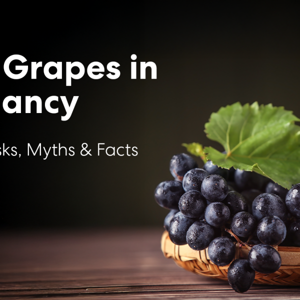 Black grapes during pregnancy showing fresh grapes with leaves on a basket