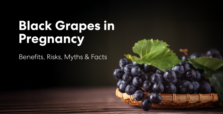 Black grapes during pregnancy showing fresh grapes with leaves on a basket